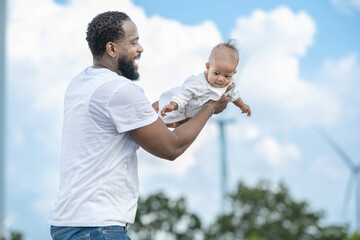 Man is holding a baby in his arms