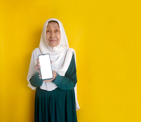 Elderly Asian Muslim Woman Showing Smartphone with Blank Vertical Screen