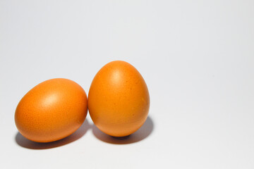 A fresh egg placed on a clean white surface, symbolizing simplicity, nutrition, and natural food. Ideal for themes related to cooking, health, or minimalism.