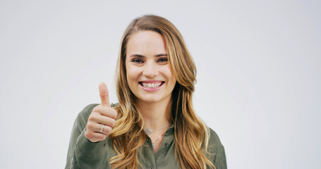 Portrait, woman and sign with thumbs up in studio for good news, agreement and like feedback....