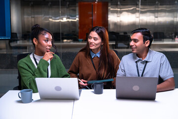 Programmer and developer team collaborates in office environment using laptops and code to create...
