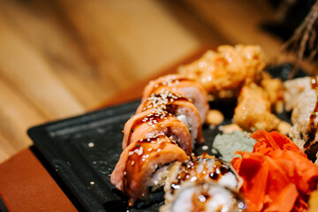 Enjoying a delightful sushi platter with various rolls and garnishes at a cozy restaurant