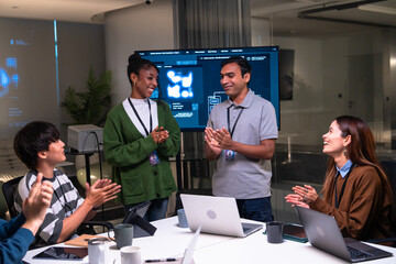 Diverse team of programmers and software developers, including Indian, African American professionals, working together night office, discussing code, project management, startup strategy,
