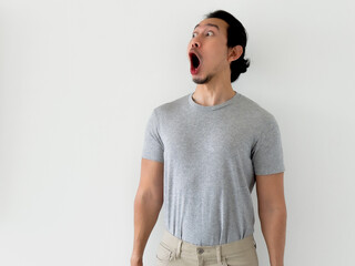 Happy surprising funny face of man isolated on white background.