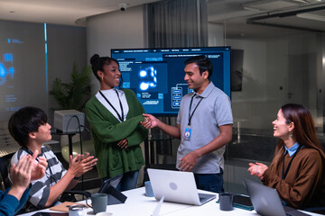 Diverse team of programmers and software developers, including Indian, African American professionals, working together night office, discussing code, project management, startup strategy,