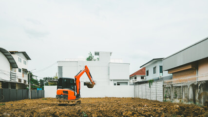 The land is being cleared by a tractor, paving the way for the construction of a house or shophouse, embodying a promising real estate investment concept.