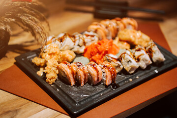 Delicious sushi platter served on a stone plate at a Japanese restaurant during dinner