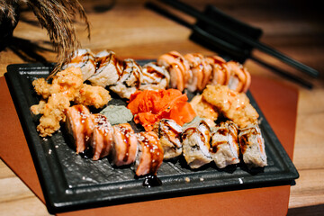 Popular sushi platter featuring variety of rolls and accompaniments presented elegantly
