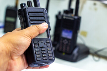 Hand holding a two-way radio for communication