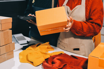 Portrait of Starting small businesses SME owners, two Asian woman check online orders Selling...