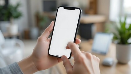 	
Close-up of a person holding a modern smartphone with a blank white screen	
