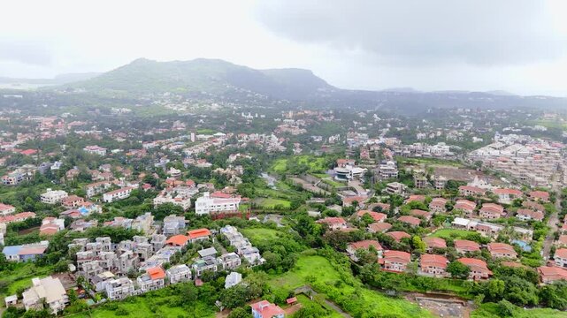 Aerial View of Green Hills and Modern Homes at Suburban