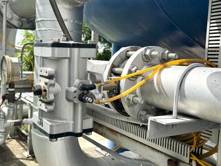 oil industry equipment. Close-up of industrial pneumatic actuator and piping system with pressure...