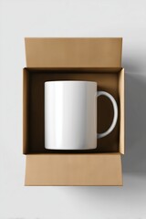 White ceramic mug placed in a brown cardboard box  