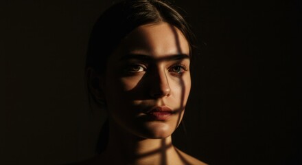 Young woman with shadows on face in low light environment  