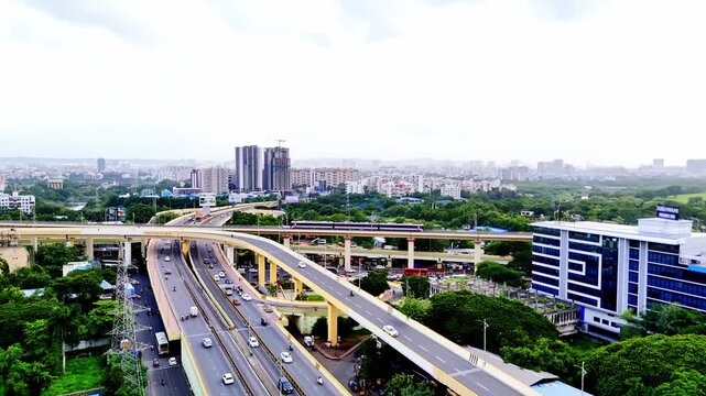 Drone shot steady traffic beneath elevated metro lines