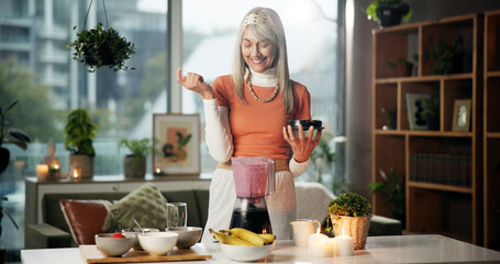 Smoothie, happy and mature woman with blender for healthy gut, benefits and wellness in kitchen....