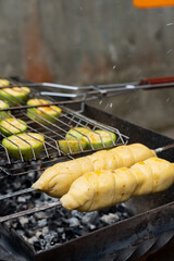 Chopped zucchini and khachapuri roasting on fire seasoned with aroma herbs and spices. Delicious...