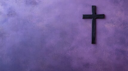 Dark wooden cross on textured purple wall