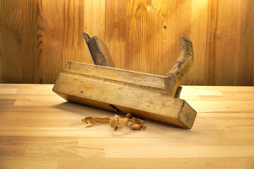 Antique Wooden Hand Plane on Carpenter's Workbench with Wood Shavings