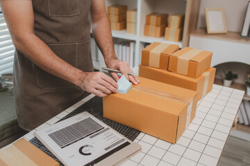 an employee is packing products into boxes to prepare for shipping to customers, a small online...