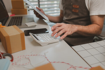 an entrepreneur has his own small online business, the business owner checks the package before...