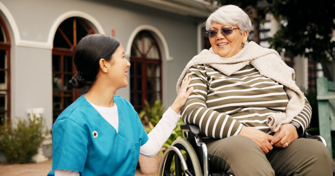 Happy, outdoor and nurse with senior woman in wheelchair for fresh air, wellness and support. Retirement, nursing home and caregiver talking to elderly person with disability in garden for relaxing