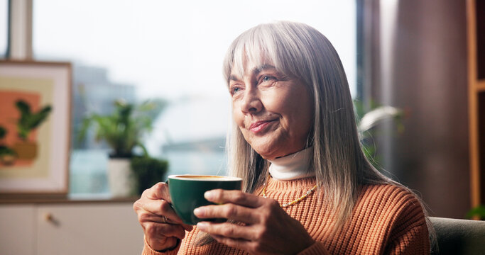 Senior woman, coffee and thinking in home with happy memory, daydreaming and peaceful break. Smile, relax and old person with warm beverage on sofa for retirement, nostalgia and reflection in lounge