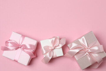 gift boxes, hearts on pink background with space for text