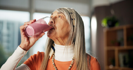 Smoothie, drinking and mature woman in home for gut health, benefits and wellness in morning....