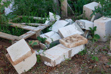 broken bricks and wooden planks lie on the ground