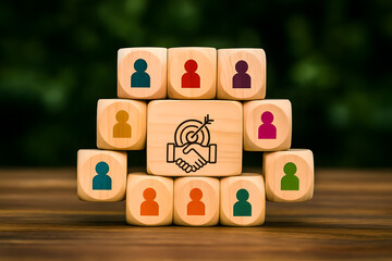 Concept of teamwork and target achievement using wooden figures and bullseye target for business and leadership visuals