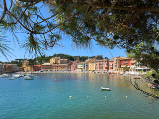 View from rock on sea, Bay of Silence, fishing cove of the town of Sestri-Levante, Italy. Tourism and recreation. Ecologically clean nature. Traditional old buildings. Historical center.