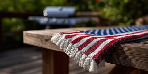 vintage american flag, focused on a vintage american flag on a picnic table, with a blurred barbecue and family gathering in the background