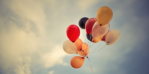 A beautiful cluster of colorful balloons floats in the sky on a bright day.