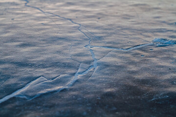 Fantastic winter landscape. Frozen grass in the snow. Winter nature in the rays of sunset..