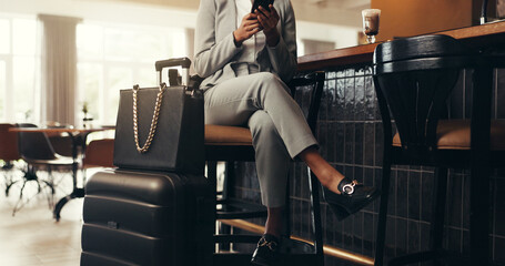 Woman, legs and waiting with luggage or phone in hotel for accommodation, travel or schedule flight. Female person, bags or suitcase with mobile smartphone for time, delay or commute in luxury cafe