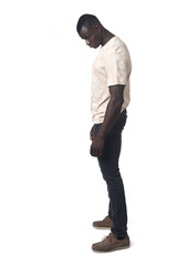 side view of a man standing and looking down on white background