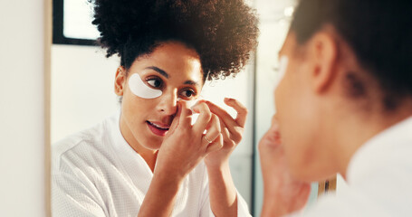 Eye mask, skincare and woman by mirror in bathroom for hydration, glow or facial routine in...