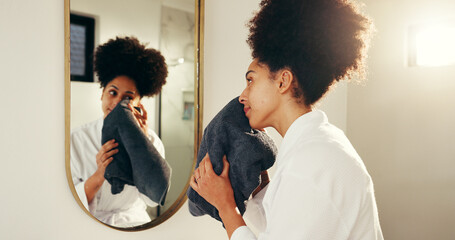Woman, mirror and skincare with towel for morning routine in bathroom, washing face or grooming....