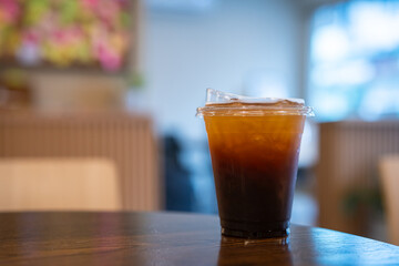 Close-up of Americano ice coffee or black coffee in cup mug on  wood desk office desk in coffee...
