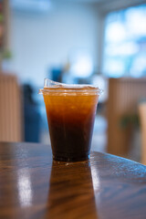 Close-up of Americano ice coffee or black coffee in cup mug on  wood desk office desk in coffee...