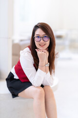 Portrait of beautiful happy Smiling asian woman relaxing sitting in cafe interior in coffee shop...