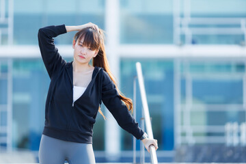 Portrait of beautiful asian Young woman in Black robe sportswear working out outside. training on...