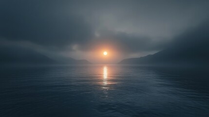 A moody, atmospheric sunset over a calm body of water, shrouded in mist and low-hanging clouds, creating a serene yet mysterious ambiance.  The sun's reflection is visible on the water's surface