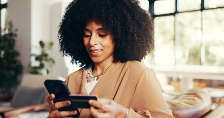 Woman, credit card and phone on sofa for ecommerce, connectivity and smile for discount. African...