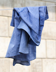 A blue cloth is hanging on a clothesline