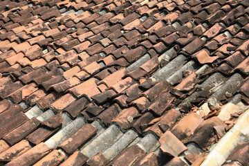 The roof is made of tiles and has a brown color