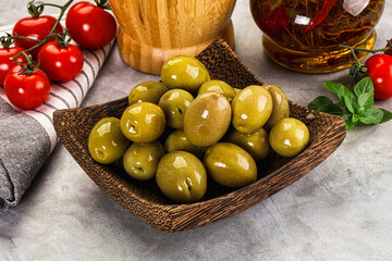 Big green marinated olives in the bowl