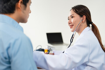 Asian doctor talk with patient about disease symptom, doctor use stethoscope listening lung of...